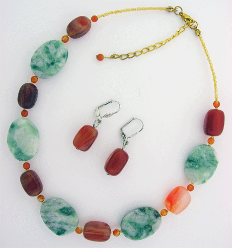 Close-up of Green Mass and Brazilian Fire Agate Natural Stone necklace showing oval shaped stones with striking green and red colors