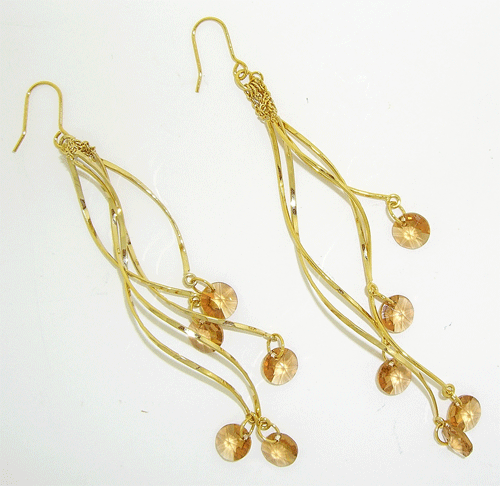 Close-up of stunning 12cm long Champaign Swarovski Golden Drop Earrings featuring 5 dangling precision-cut crystals
