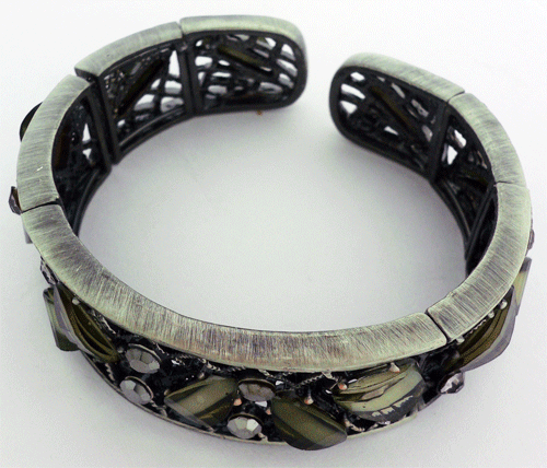 Antique gold bracelet adorned with vibrant green gemstones reflecting historical craftsmanship