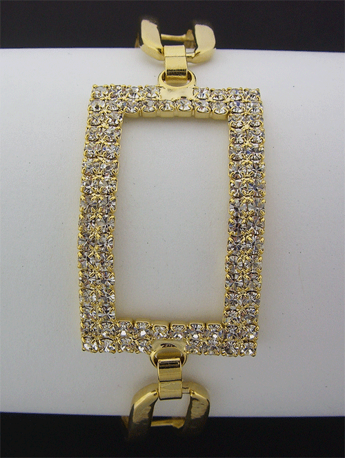 Beautiful rectangular shaped golden bracelet adorned with Swarovski stones on a dark velvet background