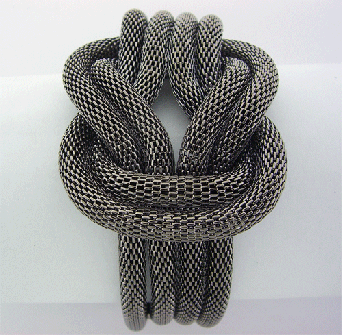 Modern black metal chain bracelet featuring a distinct knotted center design and secure clasp