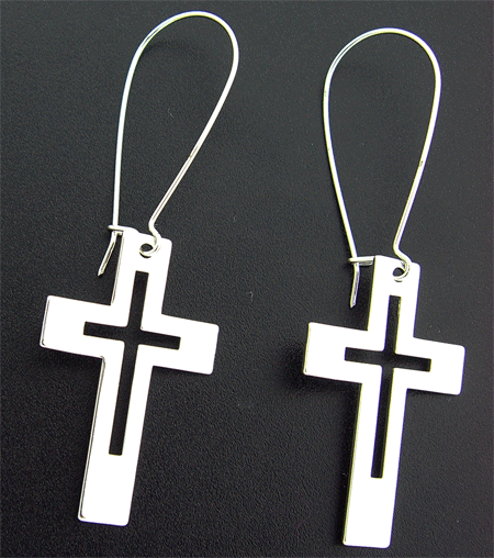 A close-up view of the detailed silver toned cross earrings, highlighting their premium craftsmanship and elegant design.