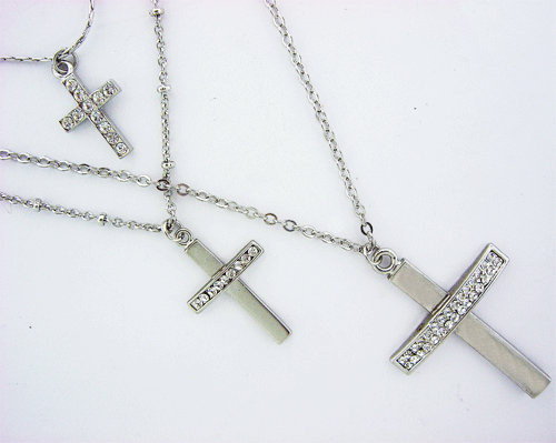 Silver necklace with three layers of chains and cross pendants featuring clear Swarovski crystals