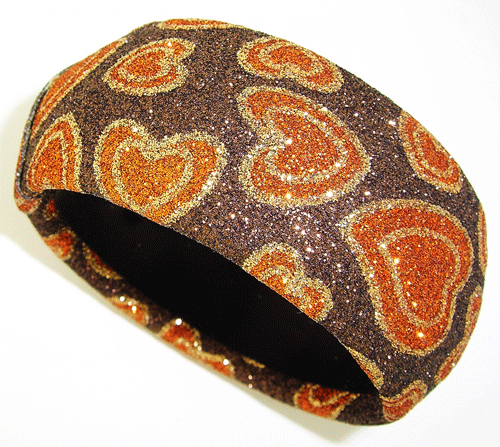 Brown Shiny Bracelet with heart design and warm summer colors on display