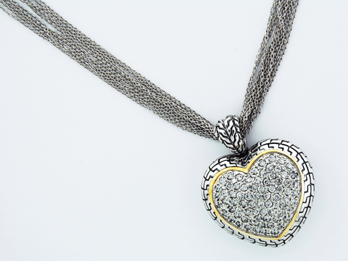 Close-up view of the 42-gram Sterling Silver Heart Pendant featuring cubic zirconias and a 14-carat gold cable
