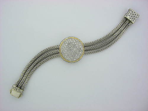 Detailed view of a 925 sterling silver bracelet accented with cubic zirconia and 14K gold plating