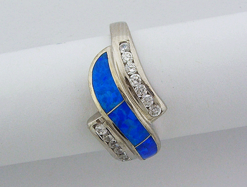 Close-up view of a 925 Sterling Silver ring featuring a vibrant Blue Opal center stone surrounded by clear Cubic Zirconias