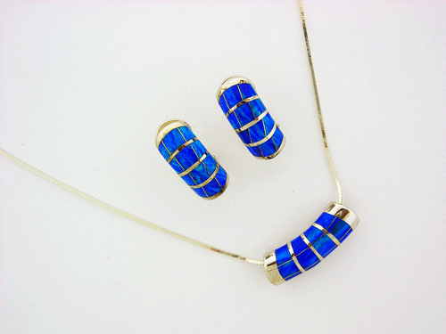 A beautiful 925 Sterling Silver necklace featuring a mesmerizing oval blue opal pendant with matching earrings, showcasing a brilliant play of color.
