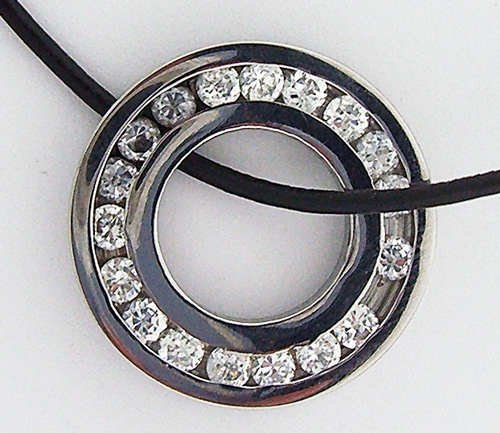 Stainless Steel Round Pendant with cubic zirconia simulated diamonds on black rubber necklace