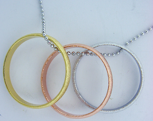 Exquisite Gold, Bronze, and Silver Ring Pendant hanging on a 15-inch silver-toned chain