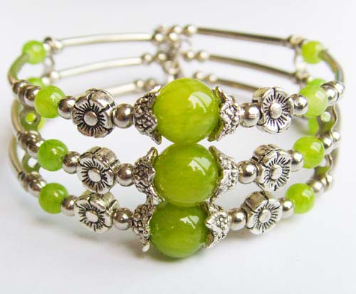 Detailed view of the Green Jade Beaded Tibet Silver Bracelet showcasing its artisan craftsmanship and green stones