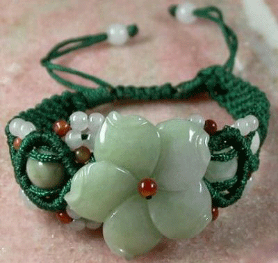 Close-up view of the Tibet hand-knitted jade flower lady's bracelet showing intricate weaving and carved green gemstone