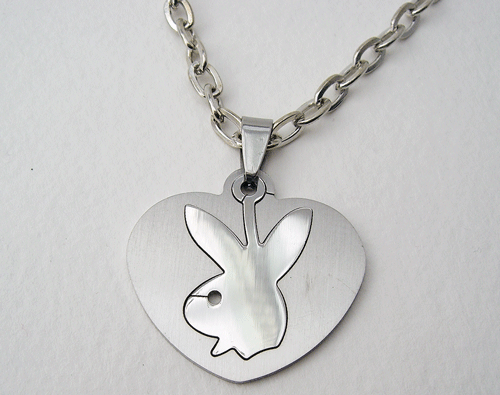 Detailed view of the Stainless Steel Heart shaped Playboy Bunny Logo Charm Necklace