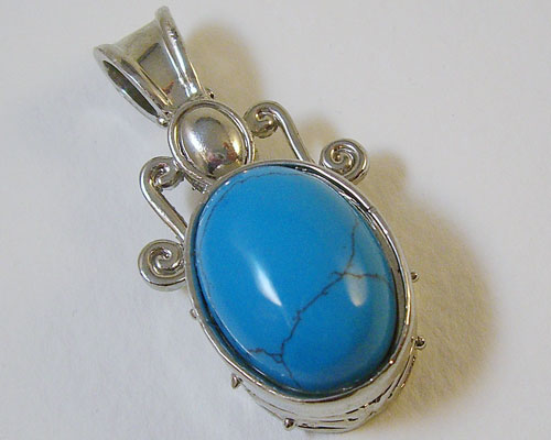 A beautiful oval Turquoise Sterling Silver Pendant displaying a rich sky-blue hue and royal silver setting