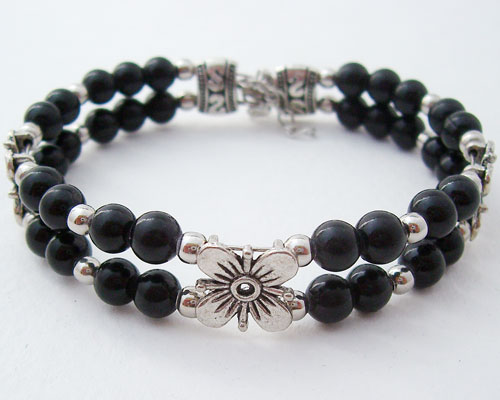Close-up view of the Black Beaded Bracelet featuring Tibetan silver and floral motifs
